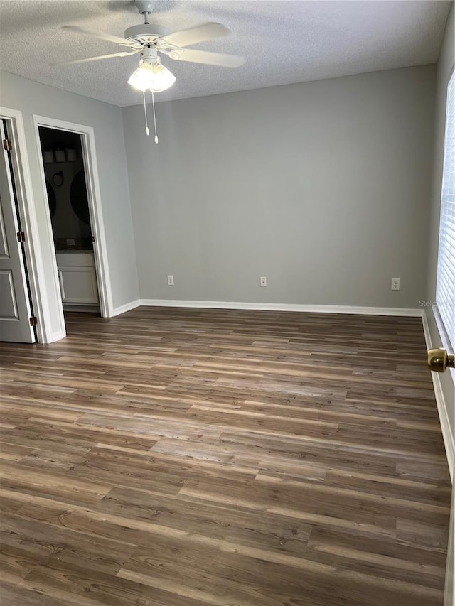 2211 Julianna Ct, Saint Cloud, FL 34769 - unfurnished room with ceiling fan, dark wood-style flooring, and a textured ceiling