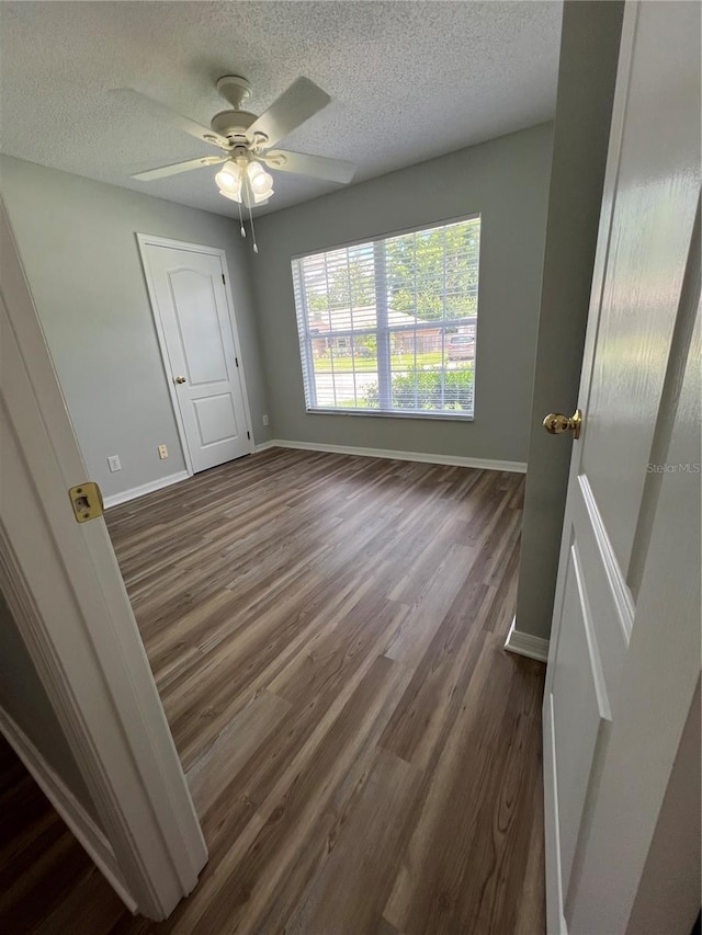 2211 Julianna Ct, Saint Cloud, FL 34769 - empty room featuring a textured ceiling, dark wood finished floors, and ceiling fan