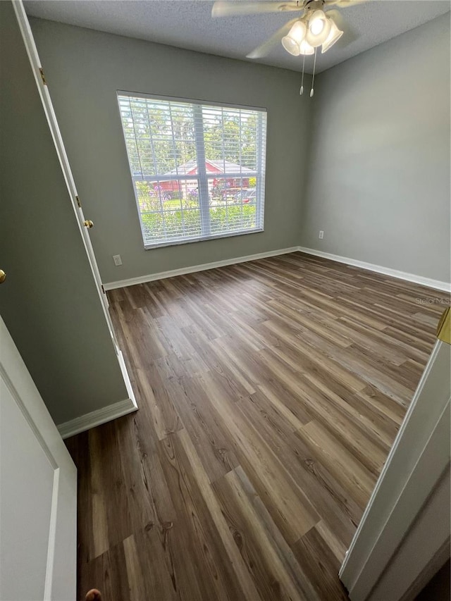 2211 Julianna Ct, Saint Cloud, FL 34769 - spare room featuring dark wood-style flooring and a ceiling fan