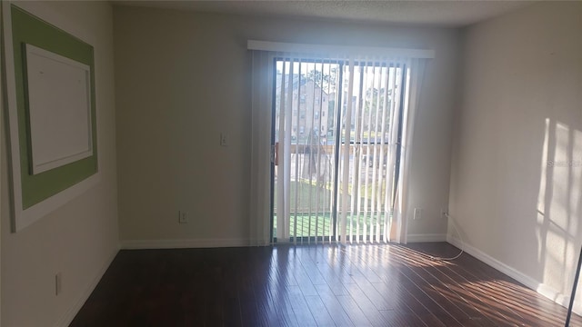 2002 Cascades Blvd Unit 207, Kissimmee, FL 34741 - unfurnished room with wood finished floors and baseboards