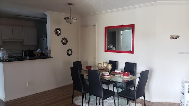 2002 Cascades Blvd Unit 207, Kissimmee, FL 34741 - dining room featuring wood finished floors, a textured ceiling, and crown molding