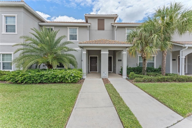 4840 Romeo Cir, Kissimmee, FL 34746 - view of front of property featuring stucco siding, a front yard, and a tile roof