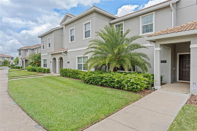 4840 Romeo Cir, Kissimmee, FL 34746 - multi unit property featuring stucco siding, a front lawn, a tile roof, and a residential view