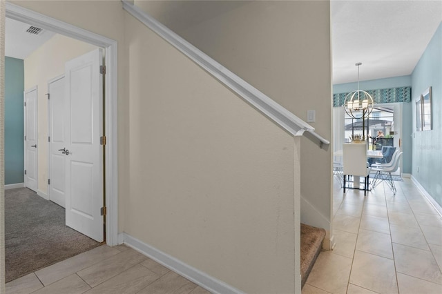 4840 Romeo Cir, Kissimmee, FL 34746 - stairs featuring a chandelier and tile patterned flooring