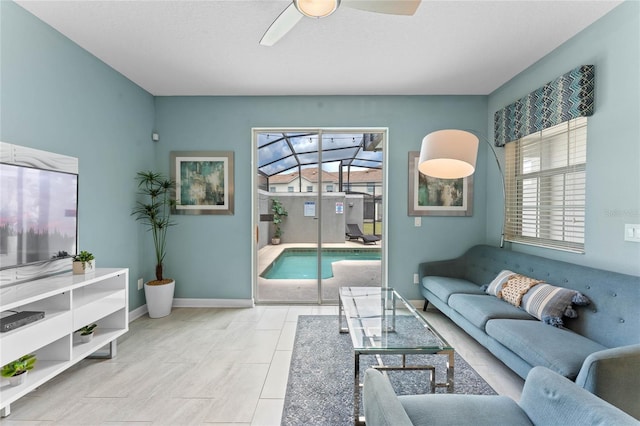 4840 Romeo Cir, Kissimmee, FL 34746 - living area featuring a ceiling fan and baseboards