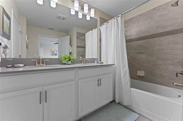 4840 Romeo Cir, Kissimmee, FL 34746 - bathroom with double vanity and shower / tub combo with curtain