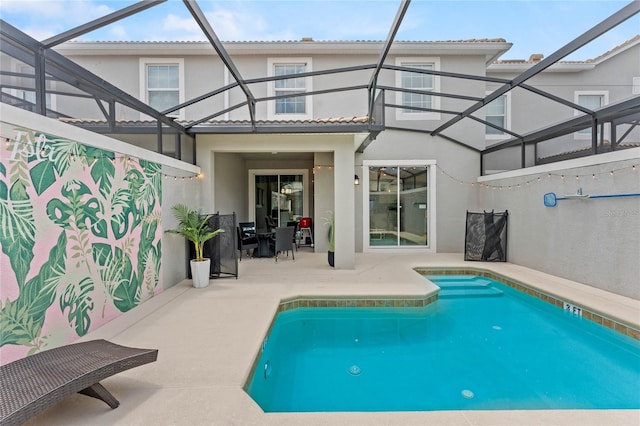 4840 Romeo Cir, Kissimmee, FL 34746 - rear view of house with stucco siding, a patio area, and glass enclosure