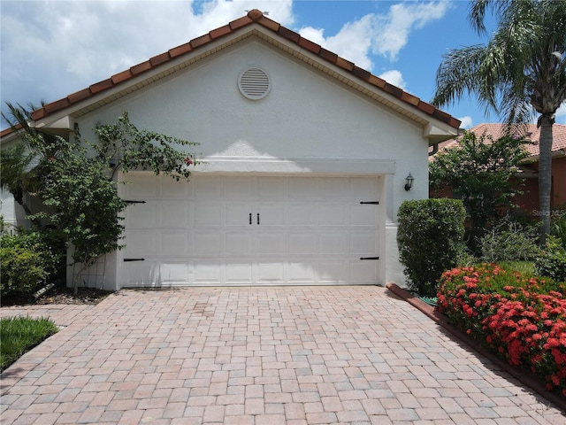 99 Auburn Dr, Kissimmee, FL 34759 - garage featuring decorative driveway