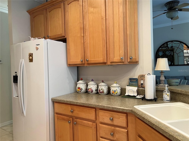 99 Auburn Dr, Kissimmee, FL 34759 - kitchen with white fridge with ice dispenser, a ceiling fan, brown cabinets, and light tile patterned floors
