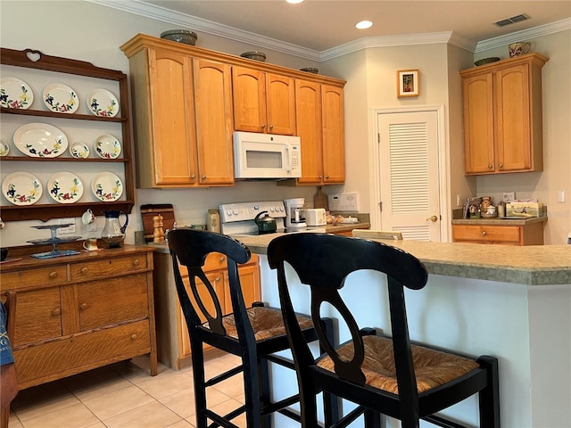 99 Auburn Dr, Kissimmee, FL 34759 - kitchen with white appliances, a kitchen bar, light tile patterned floors, open shelves, and ornamental molding