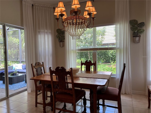 99 Auburn Dr, Kissimmee, FL 34759 - dining room with a chandelier, light tile patterned floors, and plenty of natural light