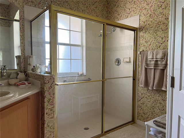 99 Auburn Dr, Kissimmee, FL 34759 - bathroom featuring wallpapered walls, a stall shower, and vanity