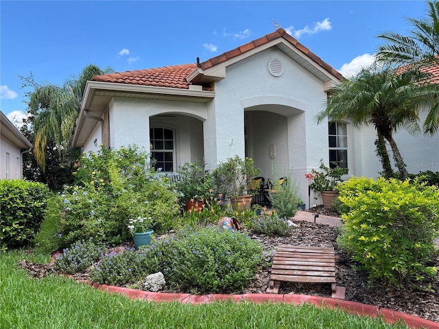 99 Auburn Dr, Kissimmee, FL 34759 - mediterranean / spanish-style house with stucco siding and a tile roof