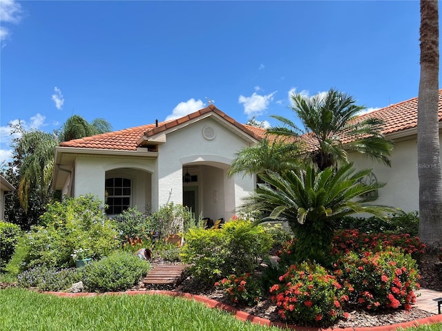 99 Auburn Dr, Kissimmee, FL 34759 - view of front of property featuring stucco siding and a tiled roof