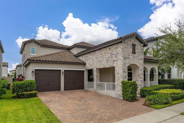 14728 Scott Key Dr, Winter Garden, FL 34787 - mediterranean / spanish house featuring an attached garage, stucco siding, decorative driveway, and a tile roof