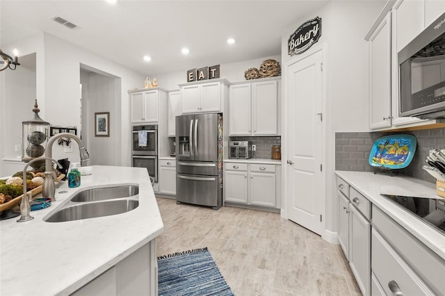 14728 Scott Key Dr, Winter Garden, FL 34787 - kitchen featuring stainless steel appliances, recessed lighting, backsplash, and white cabinetry