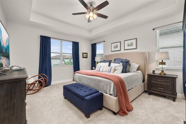 14728 Scott Key Dr, Winter Garden, FL 34787 - bedroom with light colored carpet, a tray ceiling, and a ceiling fan