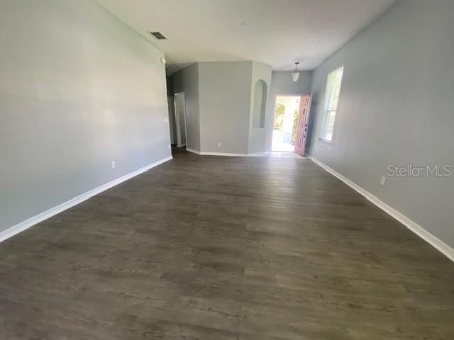 9048 Saint Andrews Way, Mount Dora, FL 32757 - spare room featuring baseboards and dark wood-type flooring
