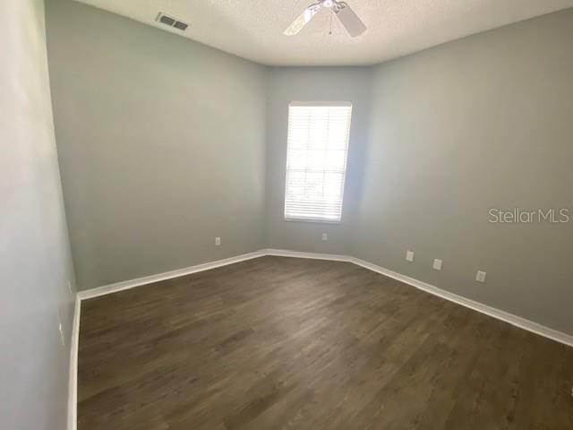 9048 Saint Andrews Way, Mount Dora, FL 32757 - spare room featuring a ceiling fan, dark wood-style floors, and a textured ceiling