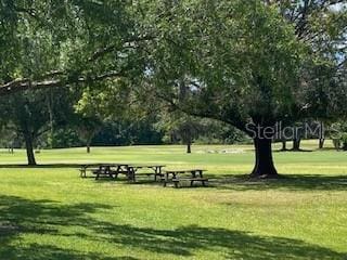 9048 Saint Andrews Way, Mount Dora, FL 32757 - view of home's community featuring a lawn, view of scattered trees, and view of golf course