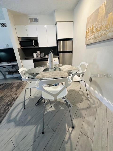 3100 Parkway Blvd Unit 316, Kissimmee, FL 34747 - dining room featuring baseboards and wood tiled floors