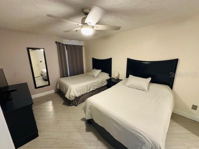 3100 Parkway Blvd Unit 316, Kissimmee, FL 34747 - bedroom featuring a textured ceiling, a ceiling fan, and wood finish floors