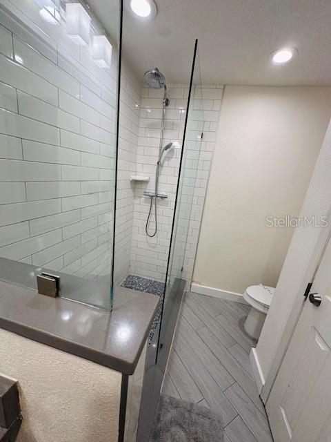 3100 Parkway Blvd Unit 316, Kissimmee, FL 34747 - bathroom with a walk in shower, recessed lighting, and wood tiled floors