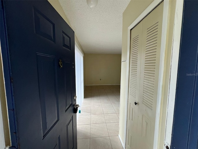 3828 Bowline Cir Unit 101, Kissimmee, FL 34741 - hallway featuring a textured ceiling and light tile patterned floors
