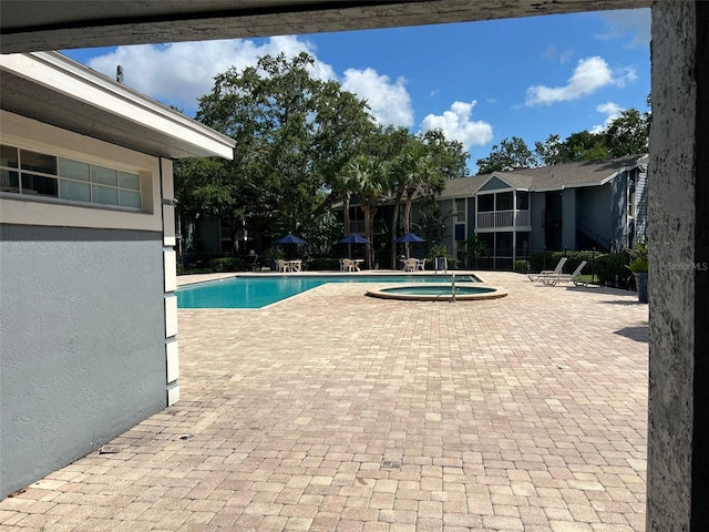 3828 Bowline Cir Unit 101, Kissimmee, FL 34741 - community pool featuring a hot tub and a patio area