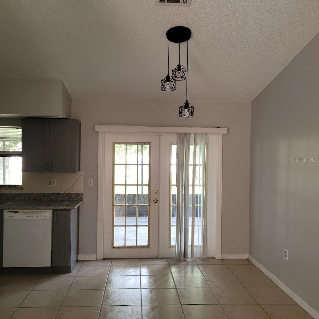 621 N Delmonte Ct, Kissimmee, FL 34758 - doorway to outside featuring a textured ceiling and light tile patterned flooring