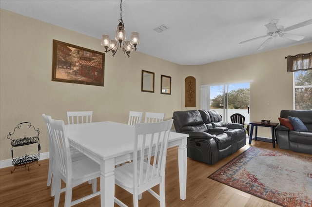 2234 Calabria Ave, Davenport, FL 33897 - dining space featuring a chandelier, wood finished floors, and a ceiling fan
