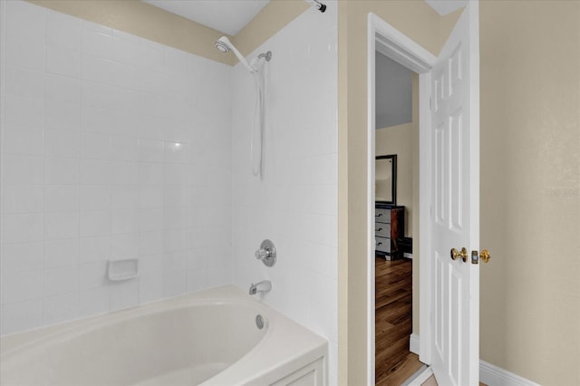 2234 Calabria Ave, Davenport, FL 33897 - bathroom featuring bathtub / shower combination and wood finished floors