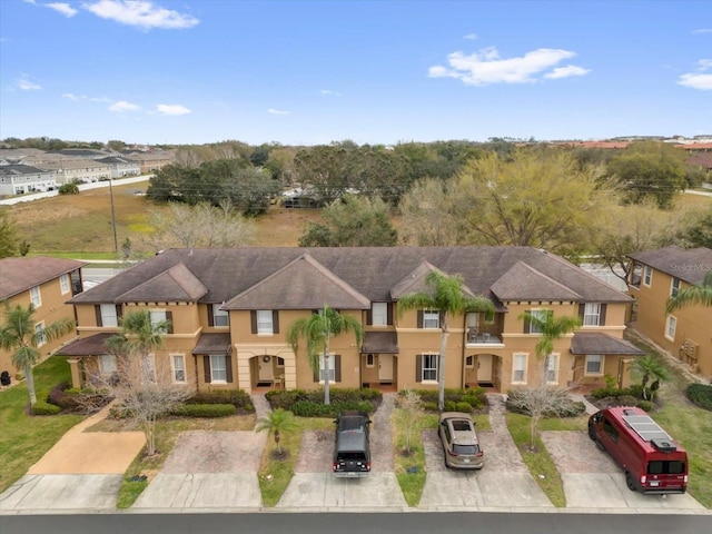 2234 Calabria Ave, Davenport, FL 33897 - mediterranean / spanish-style house featuring stucco siding, a residential view, and driveway