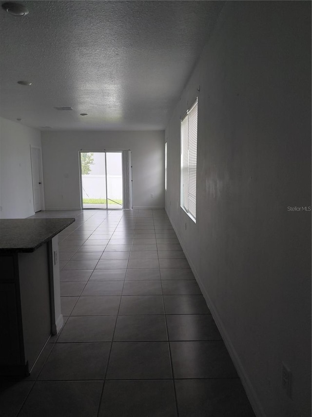 2132 Desert Rose Dr, Davenport, FL 33837 - corridor featuring a textured ceiling and tile patterned flooring