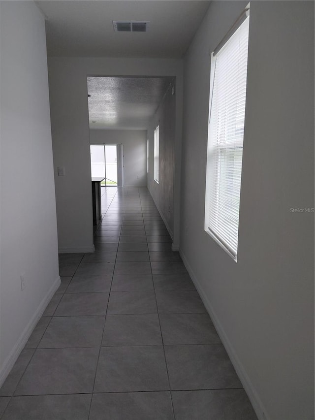 2132 Desert Rose Dr, Davenport, FL 33837 - corridor featuring tile patterned floors and baseboards