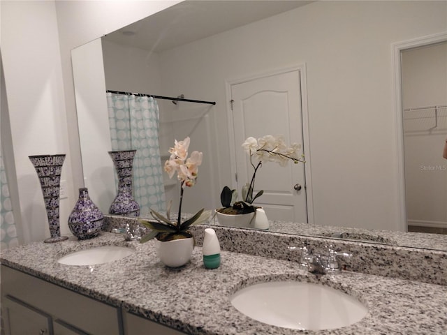 2132 Desert Rose Dr, Davenport, FL 33837 - bathroom featuring double vanity, curtained shower, and a spacious closet