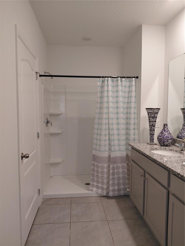 2132 Desert Rose Dr, Davenport, FL 33837 - bathroom with vanity, tile patterned flooring, and curtained shower