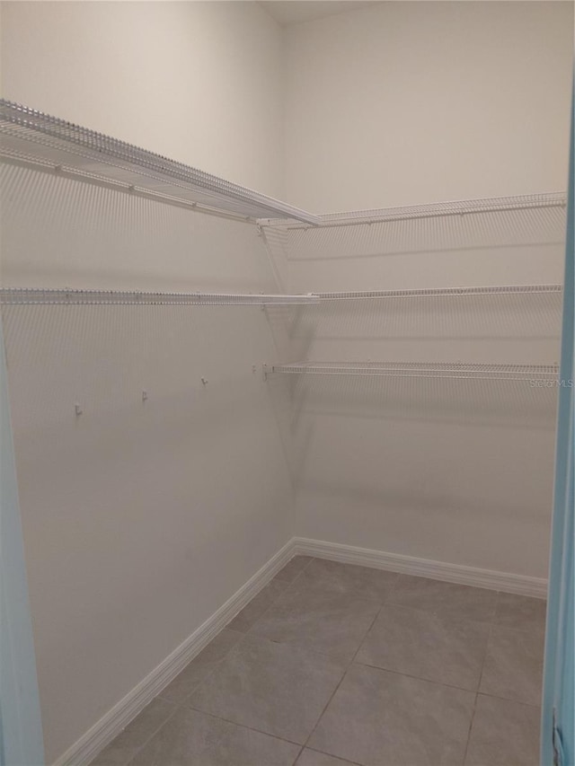 2132 Desert Rose Dr, Davenport, FL 33837 - spacious closet with tile patterned floors