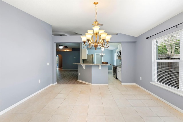 2126 Wekiva Reserve Blvd, Apopka, FL 32703 - kitchen featuring appliances with stainless steel finishes, a chandelier, arched walkways, a breakfast bar, and a peninsula