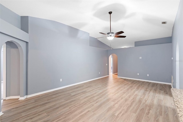 2126 Wekiva Reserve Blvd, Apopka, FL 32703 - empty room with arched walkways, a ceiling fan, vaulted ceiling, and light wood-style floors