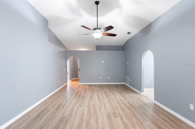 2126 Wekiva Reserve Blvd, Apopka, FL 32703 - spare room with arched walkways, ceiling fan, light wood-style flooring, and lofted ceiling