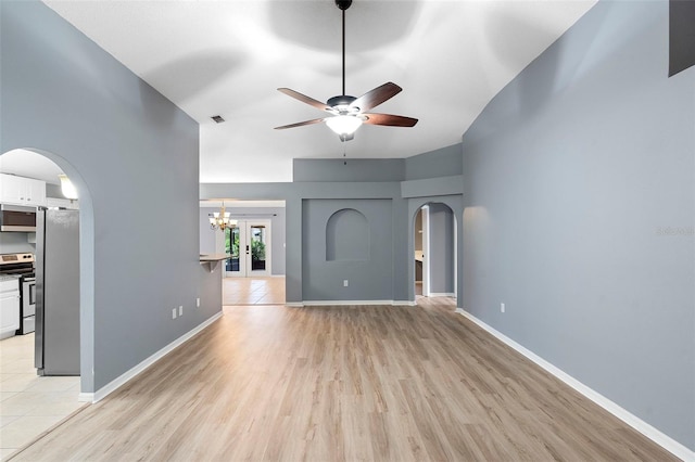 2126 Wekiva Reserve Blvd, Apopka, FL 32703 - unfurnished living room with arched walkways, light wood-style floors, ceiling fan, and a chandelier