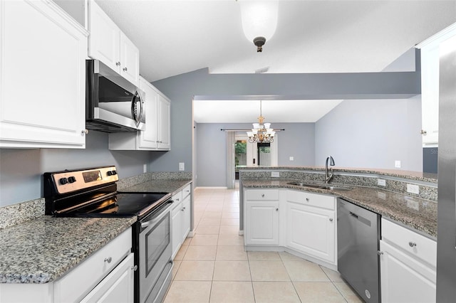 2126 Wekiva Reserve Blvd, Apopka, FL 32703 - kitchen with stainless steel appliances, a chandelier, light tile patterned floors, white cabinets, and a peninsula