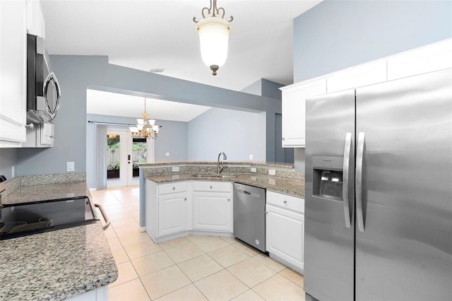 2126 Wekiva Reserve Blvd, Apopka, FL 32703 - kitchen featuring stainless steel appliances, a peninsula, white cabinets, light tile patterned floors, and a chandelier