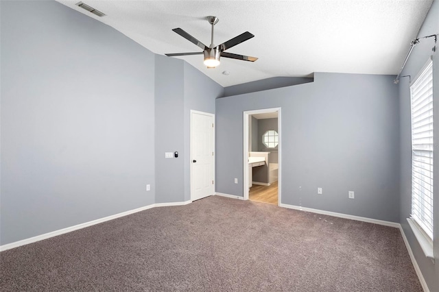 2126 Wekiva Reserve Blvd, Apopka, FL 32703 - unfurnished bedroom with lofted ceiling, carpet floors, connected bathroom, ceiling fan, and a textured ceiling