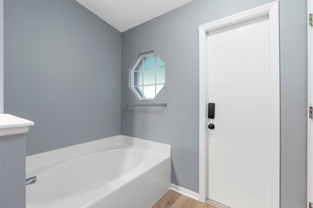 2126 Wekiva Reserve Blvd, Apopka, FL 32703 - full bathroom featuring a garden tub, wood finished floors, and a textured ceiling