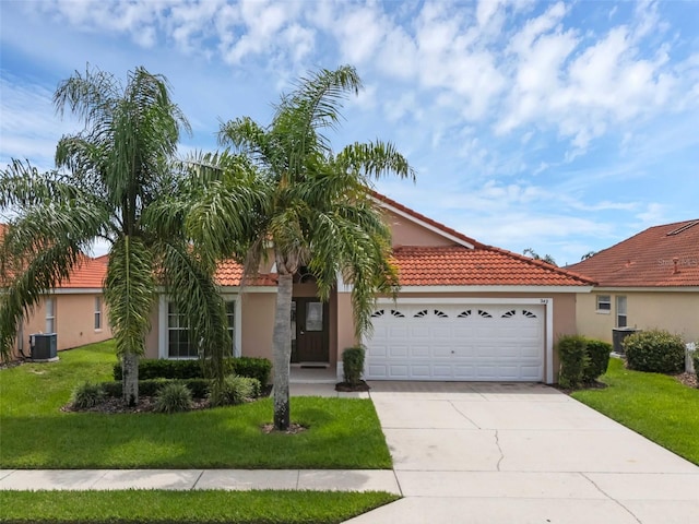 242 Saragossa Ave, Davenport, FL 33897 - view of front of house with a tile roof, stucco siding, concrete driveway, an attached garage, and a front yard
