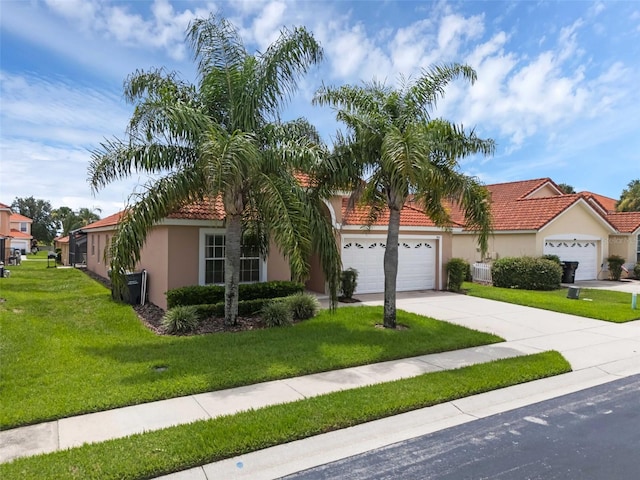 242 Saragossa Ave, Davenport, FL 33897 - view of front of house featuring stucco siding, a garage, driveway, a front lawn, and a tiled roof