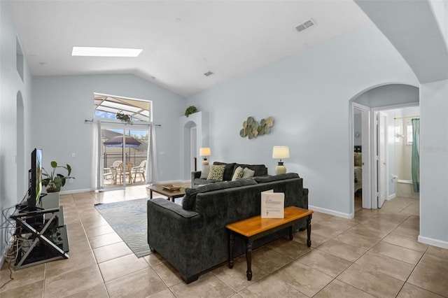 242 Saragossa Ave, Davenport, FL 33897 - living room featuring arched walkways, light tile patterned floors, and lofted ceiling