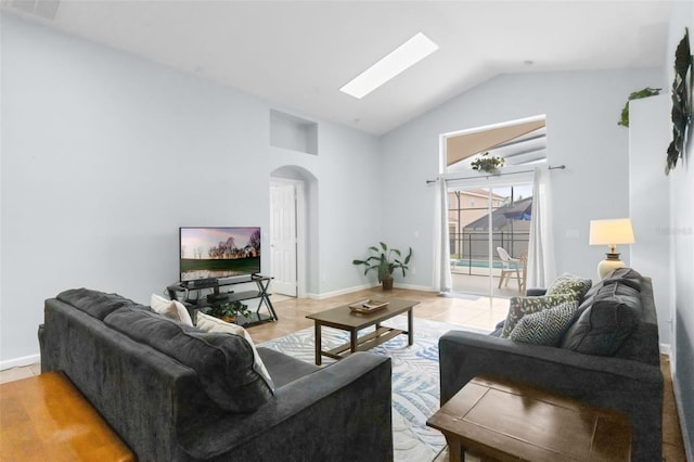 242 Saragossa Ave, Davenport, FL 33897 - living area with arched walkways, a skylight, and high vaulted ceiling